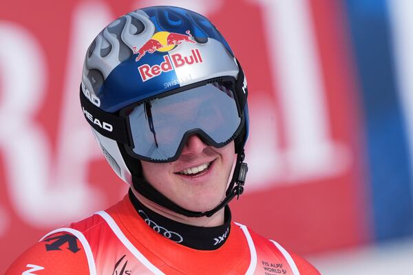 Switzerland's Franjo von Allmen celebrates at the finish area of a men's downhill race, at the Alpine Ski World Championships, in Saalbach-Hinterglemm, Austria, Sunday, Feb. 9, 2025. (AP Photo/Giovanni Auletta)