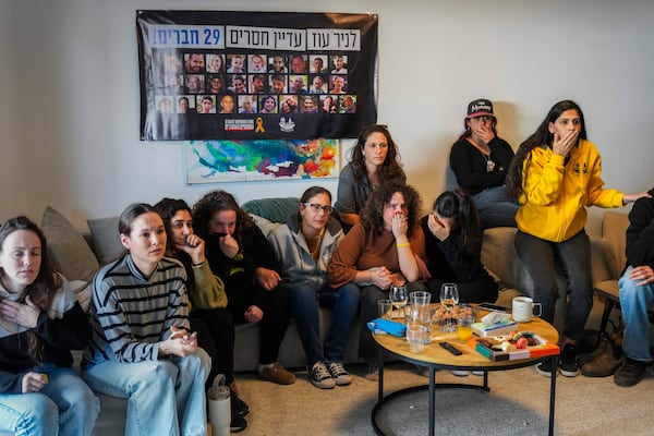 Freed hostage Shani Goren, fourth left, and friends of Israeli hostage Arbel Yehoud react as they watch the broadcast of her being released from Hamas captivity, in Carmei Gat, southern Israel, Thursday, Jan. 30, 2025, as part of the Israel-Hamas ceasefire deal. (AP Photo/Ariel Schalit)