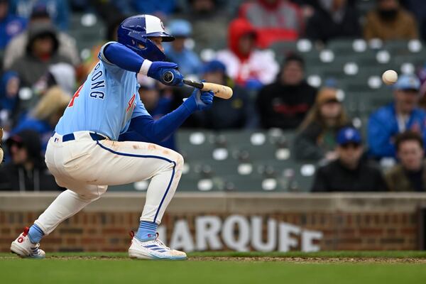 Chicago Cubs' Pete Crow-Armstrong watches his sacrifice bunt that scored Darby Swanson during the seventh inning of a baseball game against the Philadelphia Phillies, Friday, April 25, 2025, in Chicago. (AP Photo/Paul Beaty)