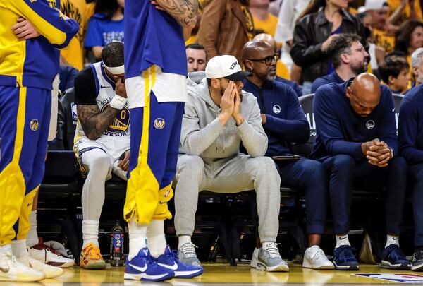 Golden State Warriors' Stephen Curry (30) and other players watch from the bench during Game 3 of an NBA basketball second-round playoff series against the Minnesota Timberwolves in San Francisco, Saturday, May 10, 2025. (Carlos Avila Gonzalez/San Francisco Chronicle via AP)
