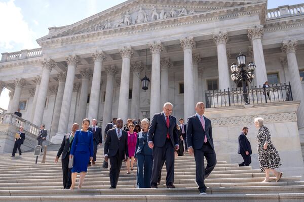 Senate Minority Leader Chuck Schumer, of N.Y., second from right, and House Minority Leader Hakeem Jeffries, of N.Y., right, arrive with other House and Senate Democrats for an event to mark 100 days of President Donald Trump's term on the steps of the Senate on Capitol Hill, Wednesday, April 30, 2025, in Washington. (AP Photo/Mark Schiefelbein)