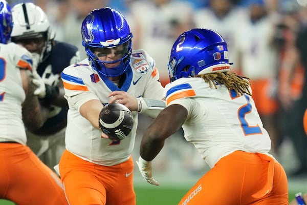 Boise State quarterback Maddux Madsen hands off to running back Ashton Jeanty (2) during the first half of the Fiesta Bowl NCAA college football CFP quarterfinal game against Penn State, Tuesday, Dec. 31, 2024, in Glendale, Ariz. (AP Photo/Ross D. Franklin)