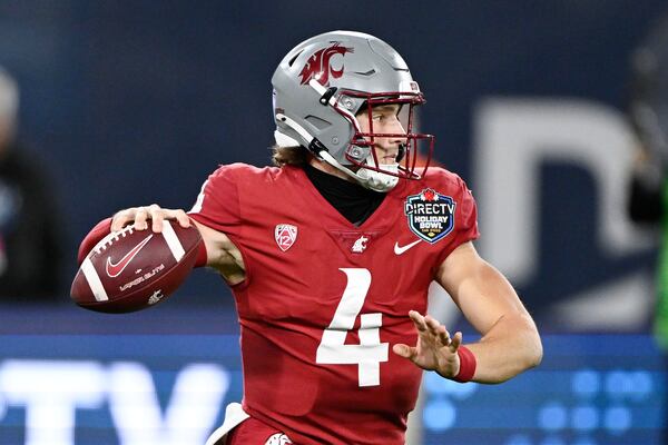 Washington State quarterback Zevi Eckhaus (4) passes during the first half of the Holiday Bowl NCAA college football game against Syracuse Friday, Dec. 27, 2024, in San Diego. (AP Photo/Denis Poroy)