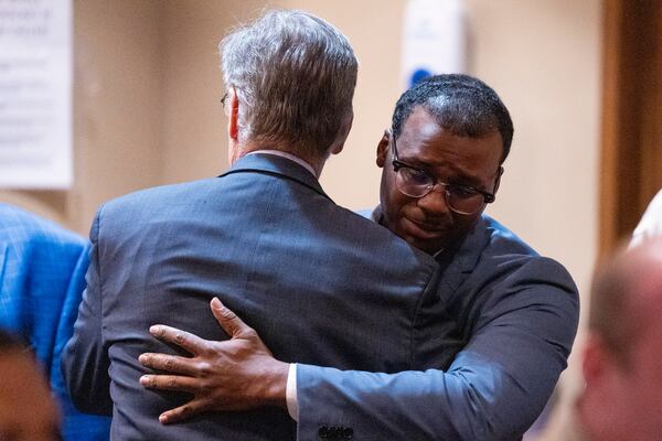 Former Memphis Police Department officer Justin Smith Jr., right, becomes emotional as he hugs Michael Stengel, left, the defense attorney for fellow former officer Demetrius Haley, after Smith and the other two former officers were found not guilty on all charges by the jury on the ninth day of the trial for the death of Tyre Nichols in Memphis, Tenn., Wednesday, May 7, 2025. (Chris Day/Commercial Appeal/USA Today Network via AP, Pool)