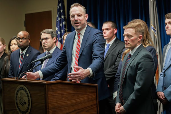 Assistant U.S. Attorney Joe Thompson, center, answers questions during a press conference at the Minneapolis federal courthouse, Wednesday, March 19, 2025, in Minneapolis, after a jury found the alleged ringleader of a massive pandemic fraud case guilty on all counts Wednesday for her role in a scheme that federal prosecutors say stole $250 million from a program meant to feed children in need. (Kerem Yücel/Minnesota Public Radio via AP)