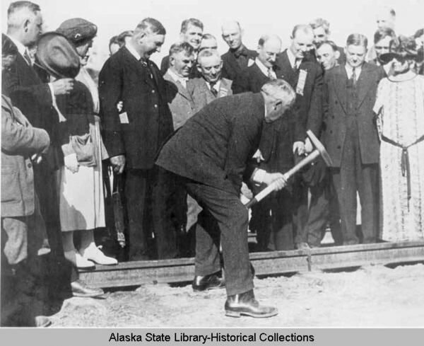 In this image, July 15, 1923, provided by the Alaska State Library Historical Collections, President Warren G. Harding drives the final golden spike at the new Alaska Railroad bridge in Nenana, Alaska. (Alaska State Library via AP)