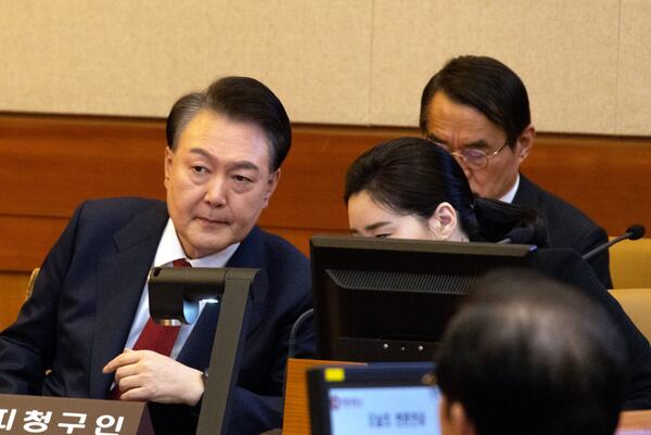 South Korea's impeached President Yoon Suk Yeol, left, attends a hearing of his impeachment trial at the Constitutional Court in Seoul, South Korea, Thursday, Feb. 13, 2025. (Joen Heon-Kyun/Pool Photo via AP)