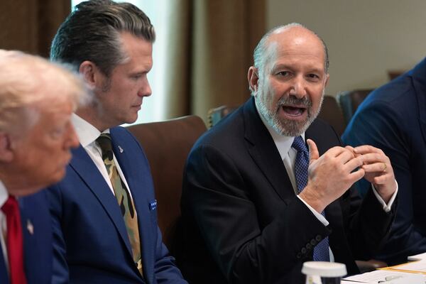 Commerce Secretary Howard Lutnick speaks during a cabinet meeting at the White House, Wednesday, April 30, 2025, in Washington, as President Donald Trump and Secretary of Defense, Pete Hegseth, look on. (AP Photo/Evan Vucci)