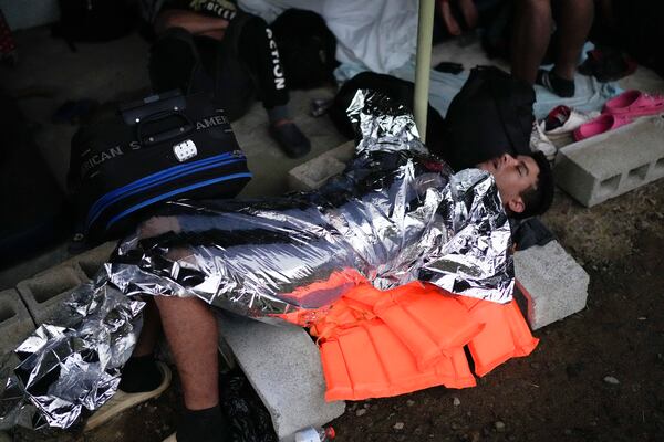 A Venezuelan migrant sleeps in Puerto Cartí, Panama's Caribbean coast, Sunday, Feb. 23, 2025, where he plans to board a boat to Colombia after turning back from southern Mexico where he gave up hopes of reaching the U.S. amid President Trump's crackdown on migration. (AP Photo/Matias Delacroix)