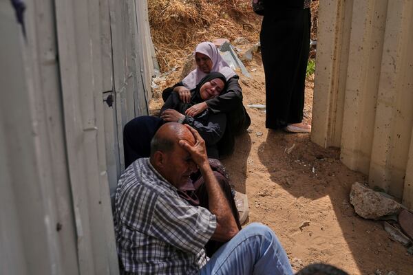 Palestinians mourn their relatives who were killed in Israeli airstrikes on a medical center in Jabalia, northern Gaza Strip, on Thursday, May 15, 2025. (AP Photo/Jehad Alshrafi)