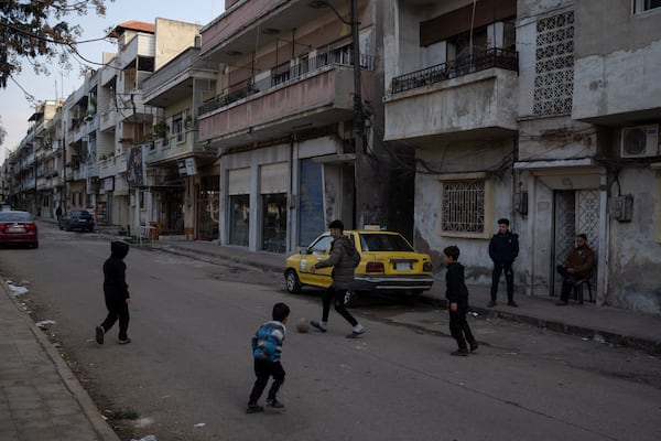 Boys play soccer on a street in an Alawite neighbourhood, in Homs, Syria, Thursday, Dec. 26, 2024. (AP Photo/Leo Correa)