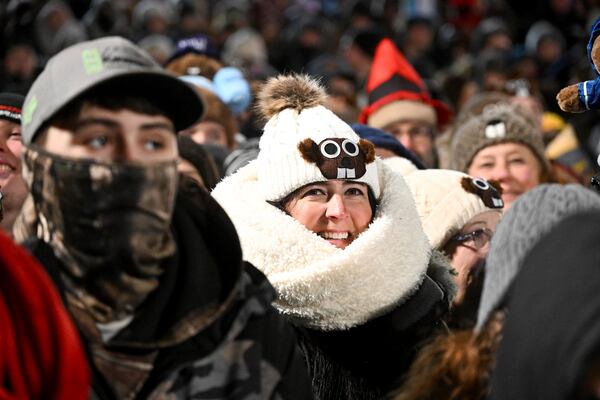 The crowd watches the festivities while waiting for Punxsutawney Phil, the weather prognosticating groundhog, to come out and make his prediction during the 139th celebration of Groundhog Day on Gobbler's Knob in Punxsutawney, Pa., Sunday, Feb. 2, 2025. (AP Photo/Barry Reeger)