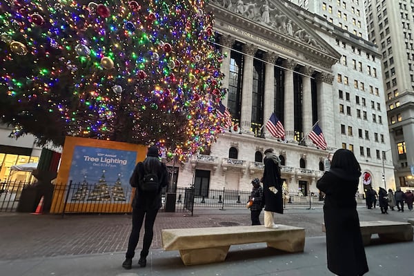 FIL:E - People photograph the New York Stock Exchange in New York's Financial District on Dec. 23, 2024. (AP Photo/Peter Morgan, File)