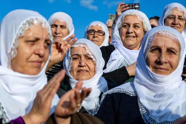 Kurdish women gather to watch live on a tv screen a Pro-Kurdish Peoples' Equality and Democracy Party, or DEM, delegation members releasing an statement from the jailed leader of the rebel Kurdistan Workers' Party, or PKK, Abdullah Ocalan, in Diyarbakir, Turkey, Thursday, Feb. 27, 2025. (AP Photo/Metin Yoksu)