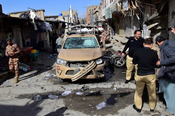 Security officials check a damaged security forces' vehicle at the site of a bomb blast in Quetta, Pakistan, Friday, Feb. 28, 2025. (AP Photo/Arshad Butt)