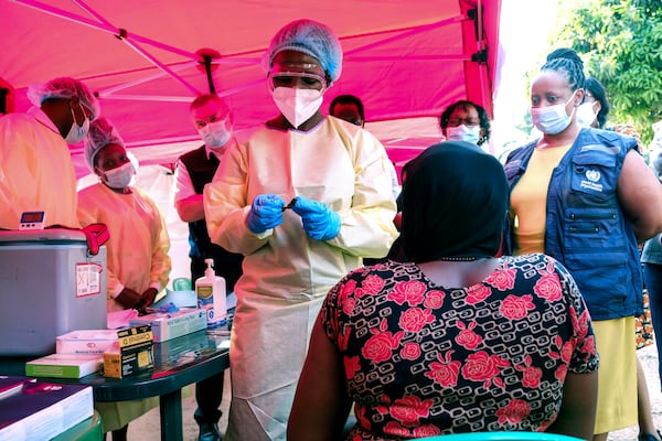 A health worker prepares to administer a vial of a vaccine against the Sudan strain of Ebola, during a trial, at Mulago Referral Hospital, in Kampala, Uganda Monday, Feb. 3, 2025. (AP Photo/Hajarah Nalwadda)