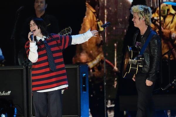 Billie Eilish, left, performs with Billie Joe Armstrong of Green Day during the FireAid benefit concert on Thursday, Jan. 30, 2025, at The Forum in Inglewood, Calif. (AP Photo/Chris Pizzello)