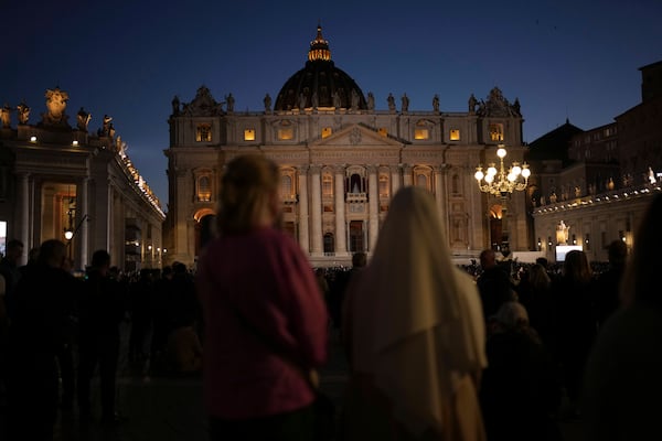 People gather in St Peter's Square as they wait to see the smoke billow from the chimney of the Sistine Chapel in St Peter's Square during the cardinals' conclave to elect a new pope, at the Vatican, Wednesday, May 7, 2025. (AP Photo/Francisco Seco)