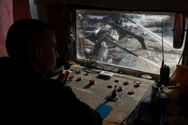 FILE - A worker controls extraction of ilmenite, a key element used to produce titanium, in an open pit mine in the central region of Kirovohrad, Ukraine, Wednesday, Feb. 12, 2025. (AP Photo/Efrem Lukatsky, File)