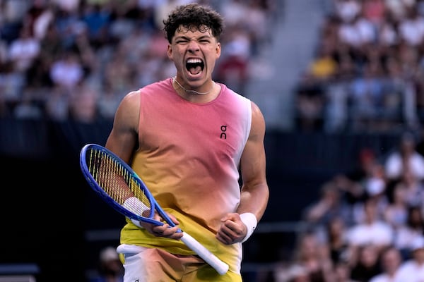 Ben Shelton of the U.S. reacts after winning a point against Lorenzo Musetti of Italy in their third round match at the Australian Open tennis championship in Melbourne, Australia, Saturday, Jan. 18, 2025. (AP Photo/Ng Han Guan)