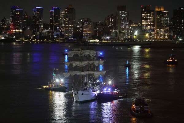 Tug boats assist the Cuauhtémoc, a masted Mexican Navy training ship, toward Pier 35 after it collided with the Brooklyn Bridge, Saturday, May 17, 2025, in New York. (AP Photo/Yuki Iwamura)