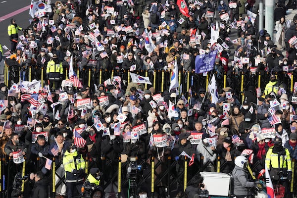 Supporters of impeached South Korean President Yoon Suk Yeol stage a rally to oppose a court having issued a warrant to detain Yoon, near the presidential residence in Seoul, South Korea, Friday, Jan. 3, 2025. The letters read, "Oppose Impeachment." (AP Photo/Lee Jin-man)