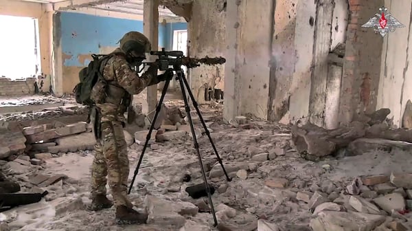 In this photo taken from video distributed by Russian Defense Ministry Press Service on Wednesday, Feb. 26, 2025, A Russian Army sniper fires toward Ukrainian position at an undisclosed location in Ukraine. (Russian Defense Ministry Press Service via AP)