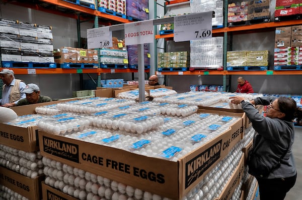 A customer selects eggs after waiting in line at a Costco store in the Van Nuys section of Los Angeles on Wednesday, Feb. 19, 2025. (AP Photo/Richard Vogel)