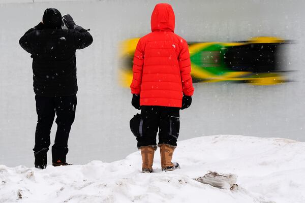 Spectators watch Adanna Johnson, of Jamaica, race during the third run in the women's monobob at the bobsledding world championships, Sunday, March 9, 2025, in Lake Placid, N.Y. (AP Photo/Julia Demaree Nikhinson)