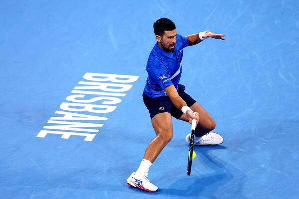 Serbia's Novak Djokovic plays a forehand to USA's Reilly Opelka during their match at the Brisbane International in Brisbane, Australia, Friday, Jan. 3, 2025. (AP Photo/Pat Hoelscher)