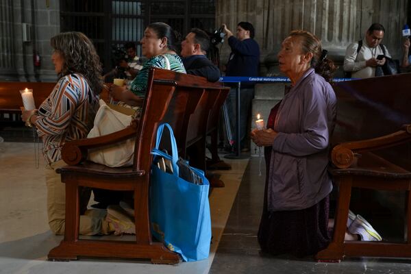 Parishioners pray for the health of Pope Francis at the Metropolitan Cathedral in Mexico City, Thursday, Feb. 27, 2025. (AP Photo/Marco Ugarte)