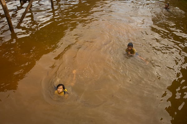 Children play in the water on Kabaena Island in South Sulawesi, Indonesia, Friday, Nov. 15, 2024. (AP Photo/Yusuf Wahil)