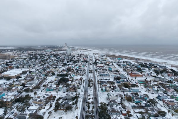 This photo provided by Michael Grimes of 409 Dronegraphy shows snow over Galveston Tx on the morning of Jan. 21, 2025. (Michael Grimes/409 Dronegraphy via AP)