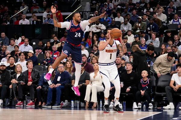 Denver Nuggets forward Michael Porter Jr., right, tries to shoot as Los Angeles Clippers guard Norman Powell defends during the second half in Game 6 of an NBA basketball first-round playoff series Thursday, May 1, 2025, in Inglewood, Calif. (AP Photo/Mark J. Terrill)