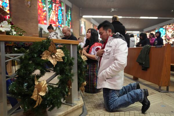 People pray at St. Mary's Catholic Church during a Mass celebrating the feast day of Guatemala's Black Christ of Esquipulas in Worthington, Minnesota, Sunday, Jan. 12, 2025. (AP Photo/Abbie Parr)