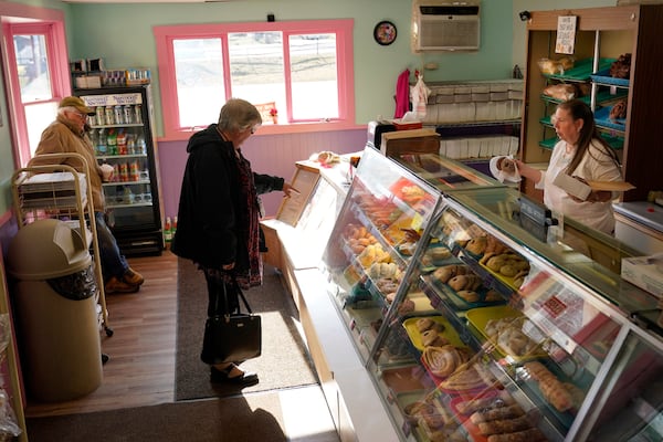 FILE - A customer selects donuts at Leavitt's Country Bakery, in this April 13, 2023, file photo in Conway, N.H. (AP Photo/Robert F. Bukaty, file)