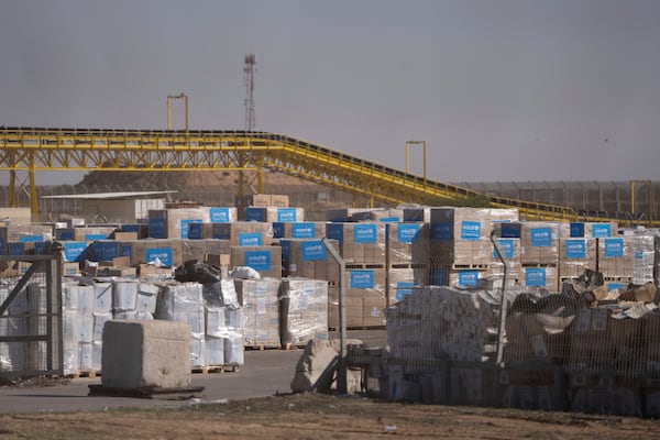 Humanitarian aid waiting to be picked up on the Palestinian side of the Kerem Shalom aid crossing in the Gaza Strip, Thursday, Dec. 19, 2024. (AP Photo/Ohad Zwigenberg)