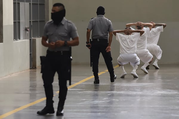 FILE - Inmates exercise under the watch of prison guards during a press tour of the Terrorism Confinement Center, or CECOT, in Tecololuca, El Salvador, Oct. 12, 2023. (AP Photo/Salvador Melendez, File)