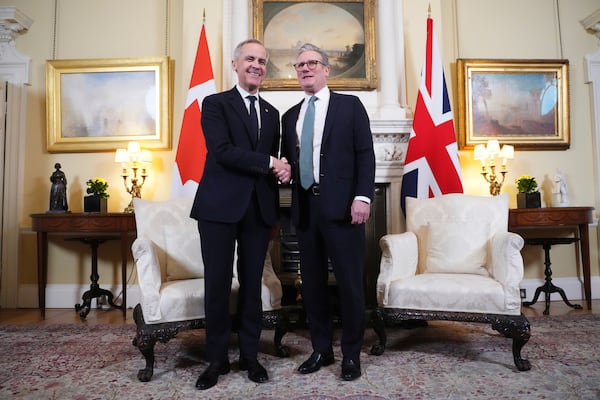 Canada Prime Minister Mark Carney is greeted by British Prime Minister Keir Starmer as he arrives in London on Monday, March 17, 2025. (Sean Kilpatrick/The Canadian Press via AP)