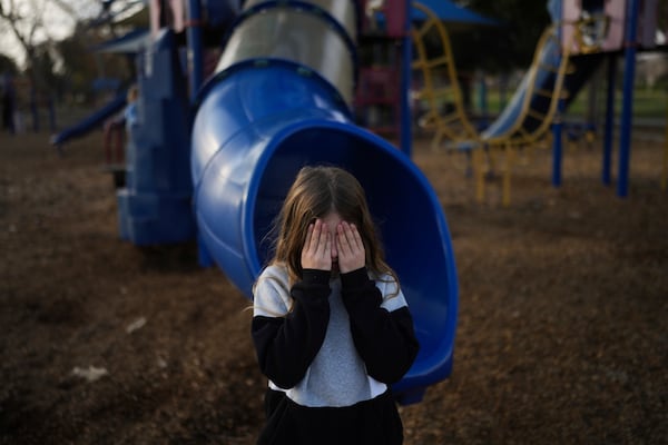 Eaton Fire evacuees Ceiba Phillips, 11, plays hide-and-seek with his 4-year-old sister, Quoia, at a park in Pasadena, Calif., Wednesday, Feb. 5, 2025. (AP Photo/Jae C. Hong)