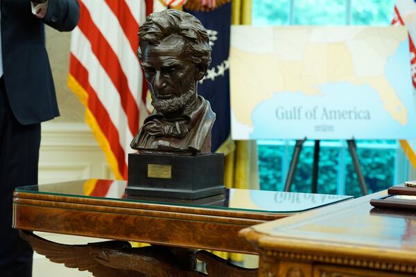 A bust of Abraham Lincoln and a map showing "Gulf of America" written on it is pictured in the Oval Office of the White House as President Donald Trump speaks during an event to announce that the 2027 NFL Draft will be held on the National Mall, Monday, May 5, 2025, in Washington. (AP Photo/Alex Brandon)