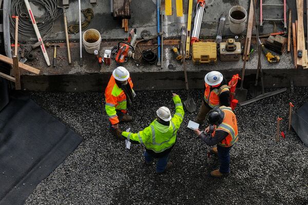 Workers talk as construction continues on Stark Street Bridge on Thursday, Feb. 6, 2025, in Troutdale, Ore. (AP Photo/Jenny Kane)