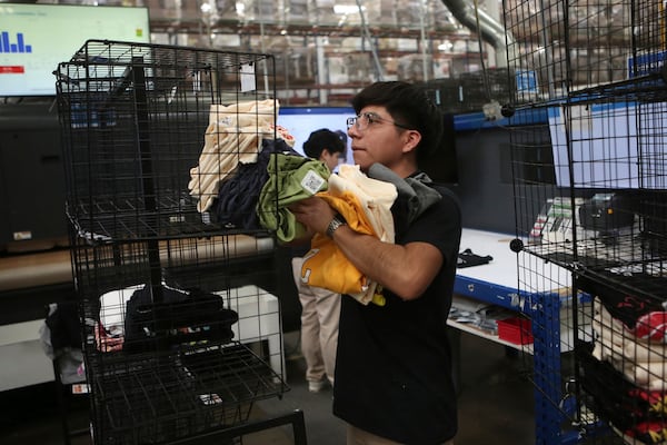 An employee works at a textile factory that produces T-shirts, in Ciudad Juarez, Mexico, Tuesday, Feb. 4, 2025. (AP Photo/Christian Chavez)