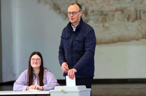 Friedrich Merz, leader of the Christian Democratic Union (CDU), casts his vote at a polling station Arnsberg-Niedereimer, Germany, Sunday, Feb. 23, 2025, during the national election. (Oliver Berg/dpa via AP)