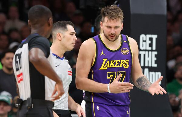 Los Angeles Lakers guard Luka Doncic (77) questions a foul call with game officials during the second half of an NBA basketball game against the Boston Celtics, Saturday, March 8, 2025, in Boston. (AP Photo/Mark Stockwell)