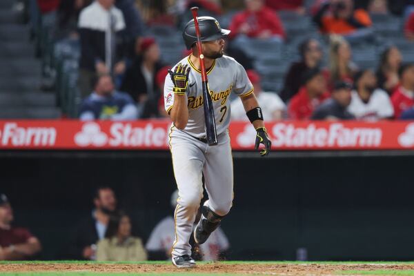 Pittsburgh Pirates' Isiah Kiner-Falefa (7) flips his bat after hitting an RBI double during the ninth inning of a baseball game against the Los Angeles Angels in Anaheim, Calif., Tuesday, April 22, 2025. (AP Photo/Jessie Alcheh)