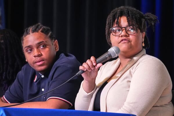 Makaila Nyambe, 17, right, and Deahmi Mobley, juniors at Perry Traditional Academy, question candidates in Pittsburgh's mayoral primary during a candidates forum in Pittsburgh, Thursday, April 24, 2025. (AP Photo/Gene J. Puskar)