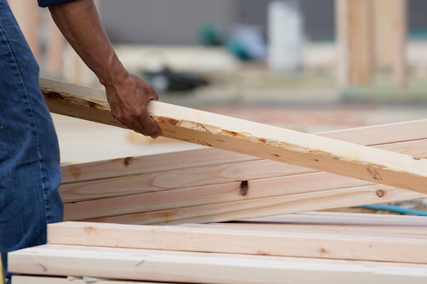 FILE - A workman arranges a beam on a frame at a new housing site in Madison County, Miss., Tuesday, March 16, 2021. (AP Photo/Rogelio V. Solis, File)