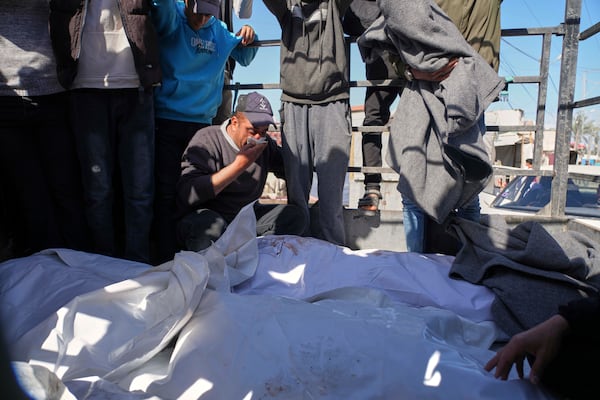 People carry the bodies of Palestinians killed in the Israeli bombardment of the Gaza Strip as they are brought for burial at Al-Aqsa Hospital in Deir al-Balah, Wednesday, March 19, 2025. (AP Photo/Abdel Kareem Hana)