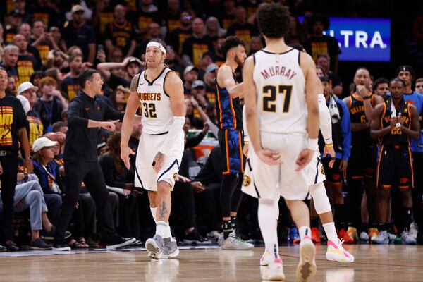 Denver Nuggets' Aaron Gordon (32) and Jamal Murray (27) celebrate after Gordon sunk a shot late in the second half of Game 1 of an NBA basketball second-round playoff series against the Oklahoma City Thunder Monday, May 5, 2025, in Oklahoma City. (AP Photo/Nate Billings)